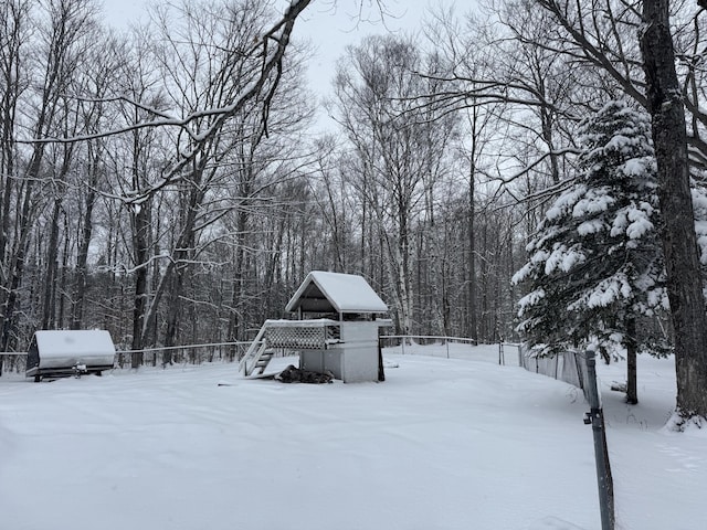 yard layered in snow with a view of trees and stairway