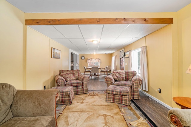 living area with wood finished floors and a drop ceiling