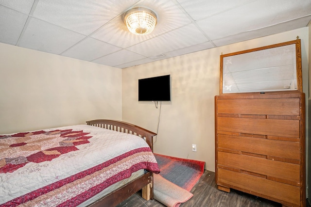 bedroom featuring a paneled ceiling and wood finished floors