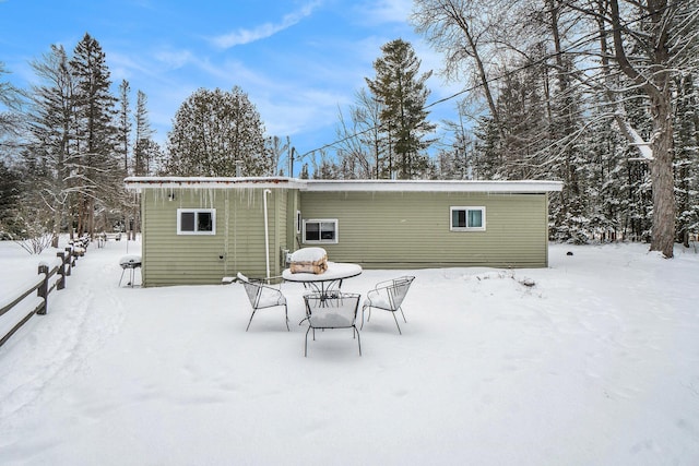 view of snow covered rear of property