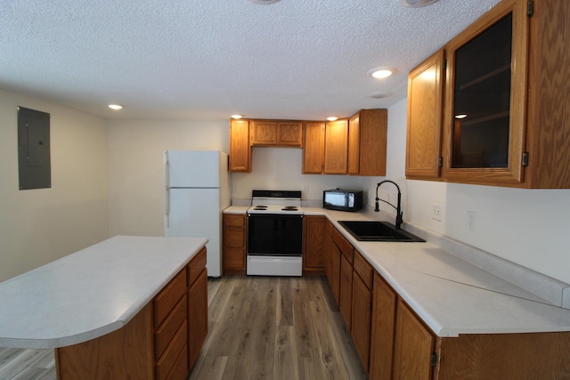 kitchen featuring electric panel, freestanding refrigerator, a sink, electric stove, and black microwave