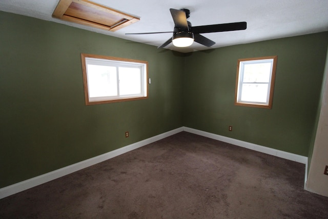 empty room with baseboards, carpet, and attic access