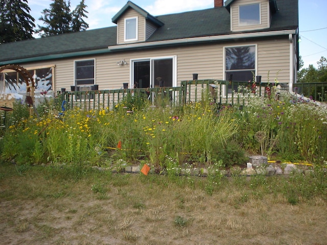 rear view of house featuring a deck and a chimney