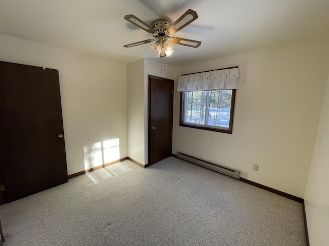 carpeted empty room with baseboards, baseboard heating, and ceiling fan