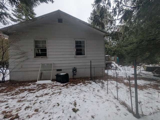 snow covered property with crawl space