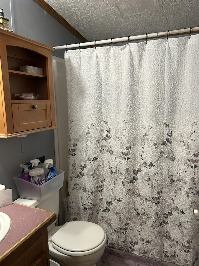 full bath with a shower with shower curtain, toilet, vanity, and a textured ceiling