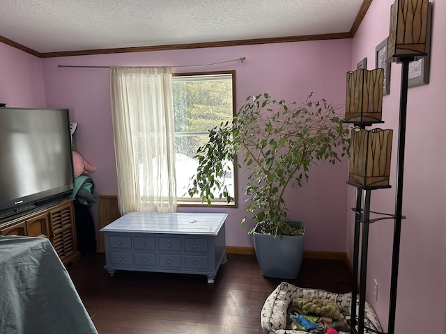 bedroom featuring dark wood-style flooring, a textured ceiling, baseboards, and ornamental molding