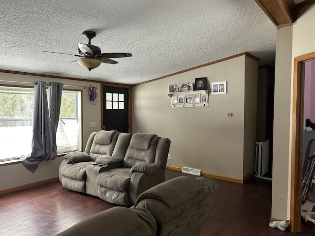 living area with visible vents, radiator, ornamental molding, wood finished floors, and a textured ceiling