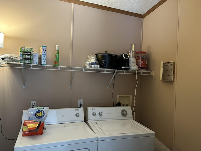 laundry room featuring washing machine and dryer, laundry area, and ornamental molding