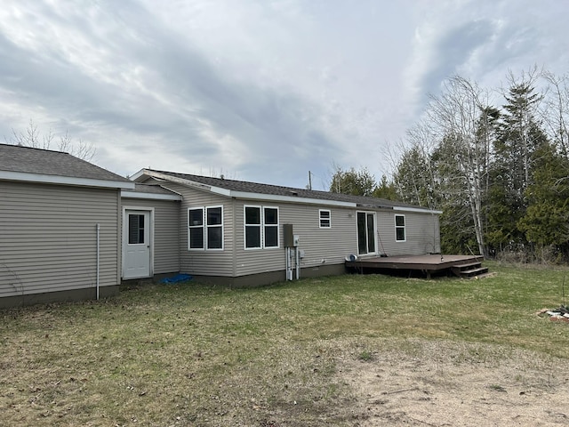 115 Sorrels Dr, Saint Ignace, MI 49781 - rear view of property with a lawn and a deck