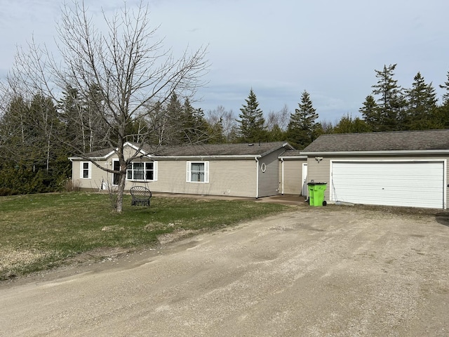 115 Sorrels Dr, Saint Ignace, MI 49781 - manufactured / mobile home with a garage and a front lawn