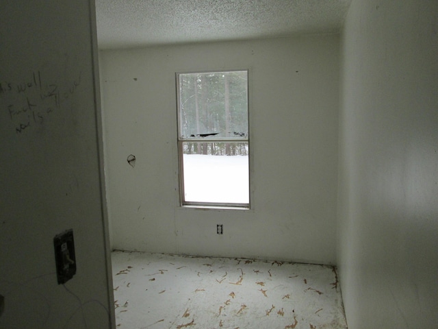 spare room featuring a textured ceiling