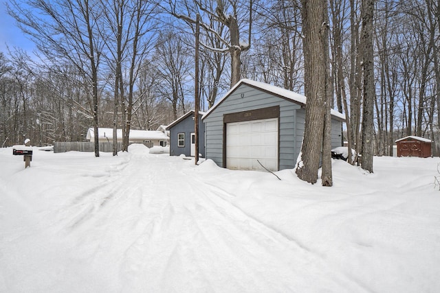 exterior space with a detached garage and an outdoor structure
