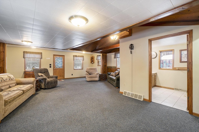 carpeted living room featuring tile patterned floors, visible vents, and baseboards