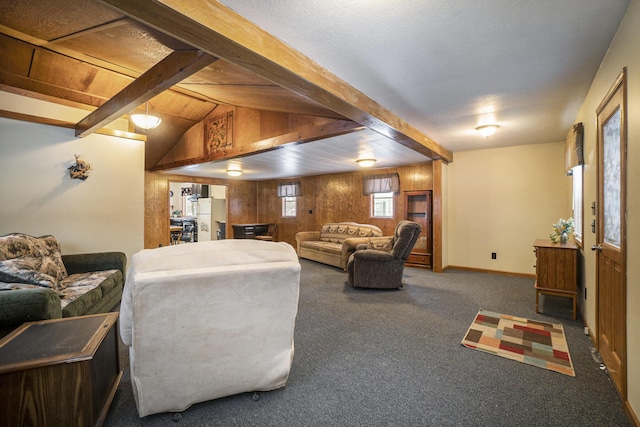 living area featuring carpet flooring, wood walls, vaulted ceiling with beams, and baseboards