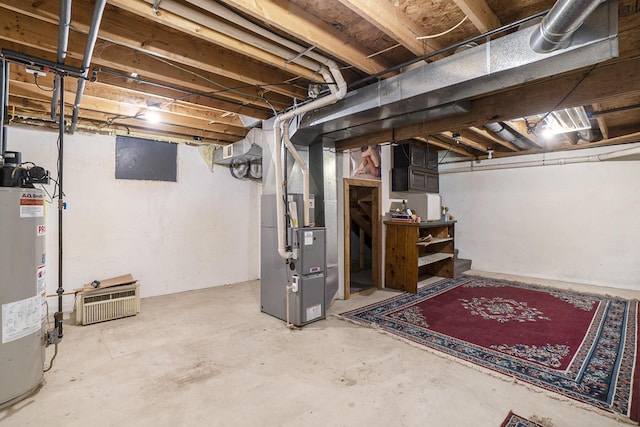 unfinished below grade area featuring heating unit and gas water heater