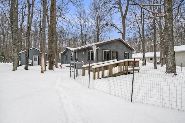 exterior space featuring a wooden deck and an outdoor structure