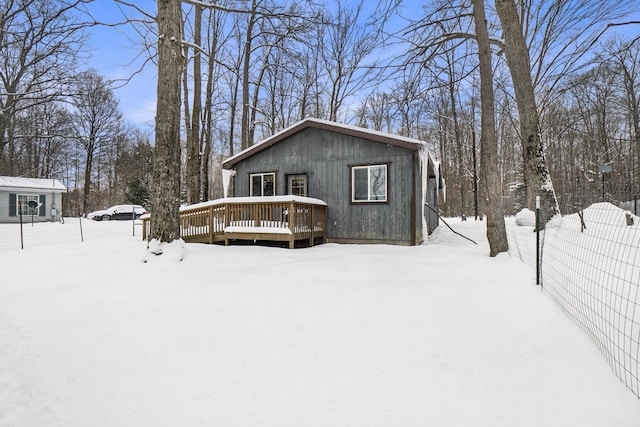 view of front of home with a deck and fence
