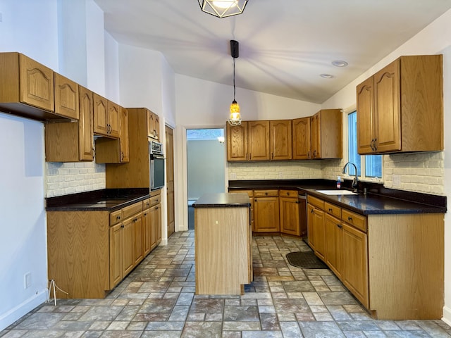 kitchen featuring lofted ceiling, a sink, appliances with stainless steel finishes, stone finish flooring, and a center island