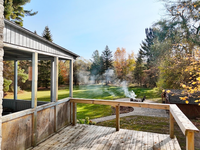 wooden deck with a lawn