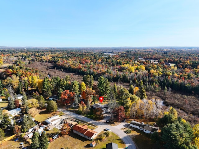 birds eye view of property with a view of trees