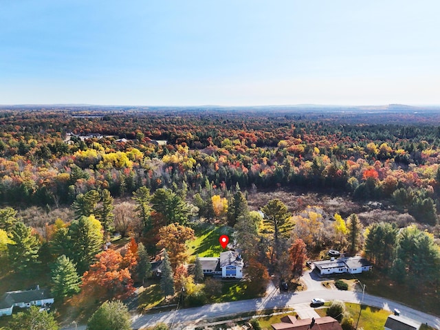 birds eye view of property with a view of trees