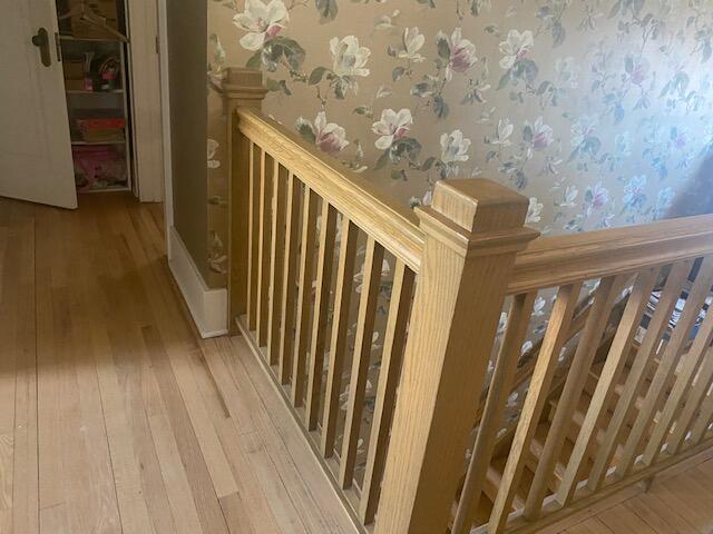 424 S State Ave, Alpena, MI 49707 - hallway with wallpapered walls and hardwood / wood-style flooring