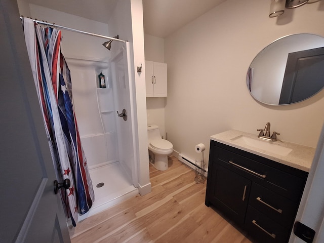 full bathroom featuring a baseboard heating unit, wood finished floors, a stall shower, toilet, and vanity