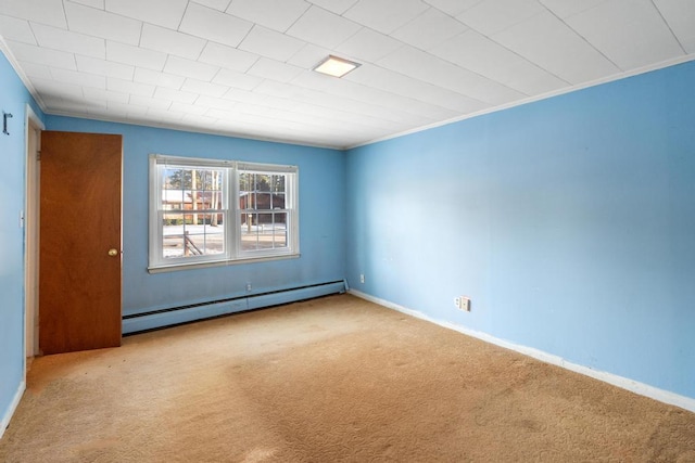 carpeted empty room with a baseboard heating unit, baseboards, and ornamental molding