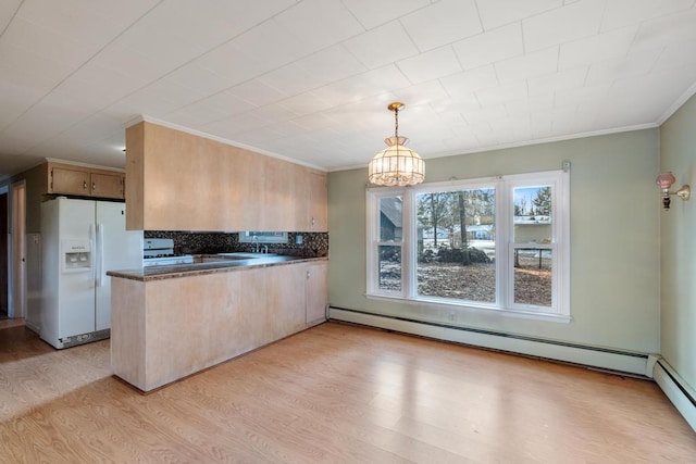 kitchen featuring dark countertops, a peninsula, white refrigerator with ice dispenser, light wood-style floors, and a baseboard radiator