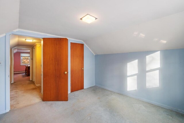 bonus room featuring baseboard heating, baseboards, carpet, and vaulted ceiling