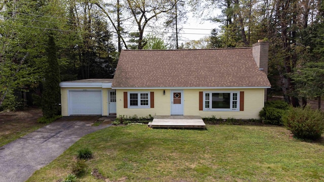 6441 Holden Rd, Indian River, MI 49749 - cape cod home with asphalt driveway, an attached garage, a chimney, a front yard, and roof with shingles