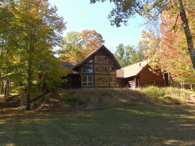 back of property featuring a lawn