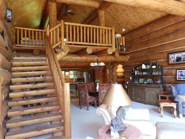 carpeted living room featuring log walls, high vaulted ceiling, wood ceiling, and stairs