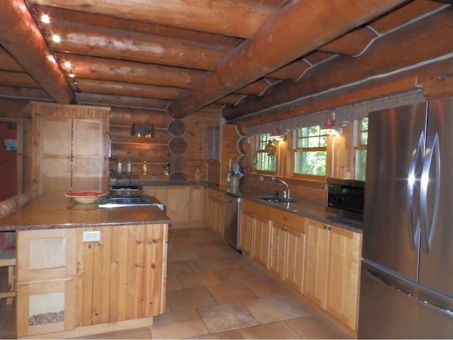 kitchen with light brown cabinetry, beam ceiling, rustic walls, stainless steel appliances, and a sink