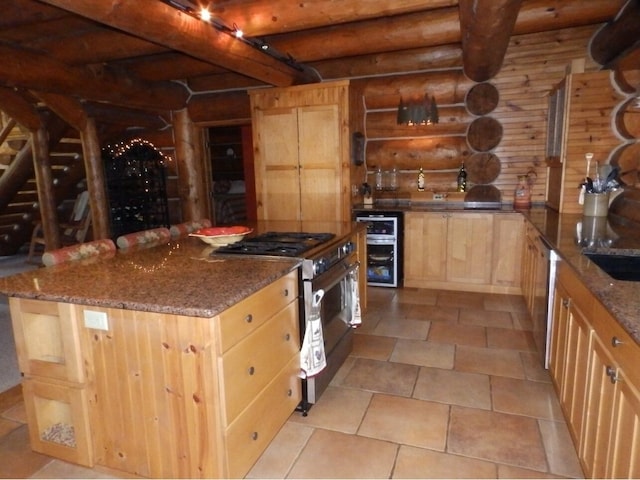 kitchen with light brown cabinets, wine cooler, stone counters, appliances with stainless steel finishes, and rustic walls