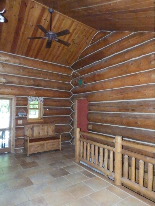 interior space featuring ceiling fan, wooden ceiling, log walls, and lofted ceiling