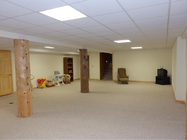 interior space with a paneled ceiling, baseboards, carpet, and stairs