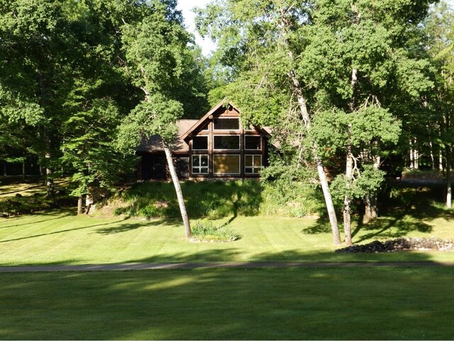 view of property's community with a lawn