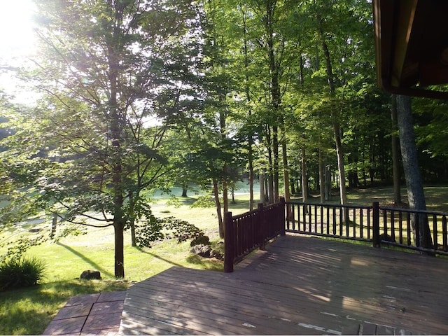 wooden deck with a lawn