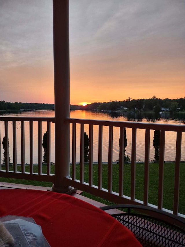 5560 Chestnut Dr, Cheboygan, MI 49721 - balcony at dusk featuring a water view