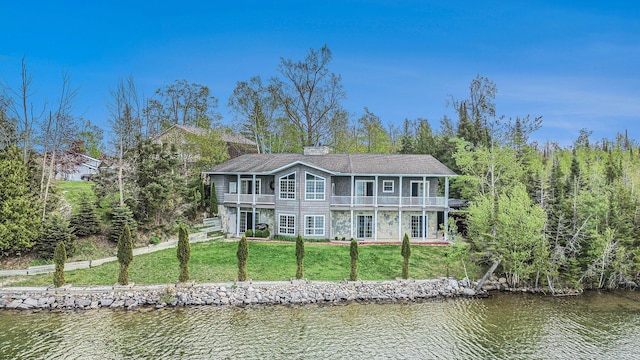 5560 Chestnut Dr, Cheboygan, MI 49721 - rear view of house with a water view, a yard, and a balcony