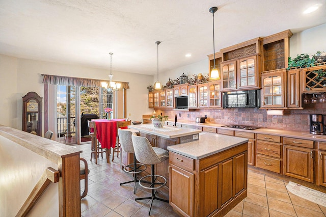 5560 Chestnut Dr, Cheboygan, MI 49721 - kitchen featuring decorative backsplash, a center island, light countertops, a kitchen bar, and recessed lighting