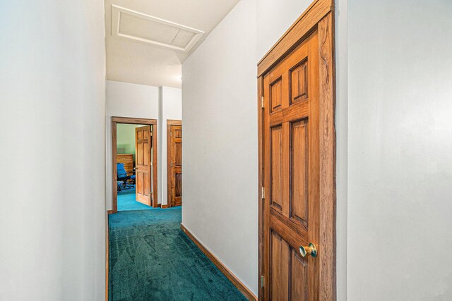5560 Chestnut Dr, Cheboygan, MI 49721 - corridor with dark colored carpet, attic access, and baseboards