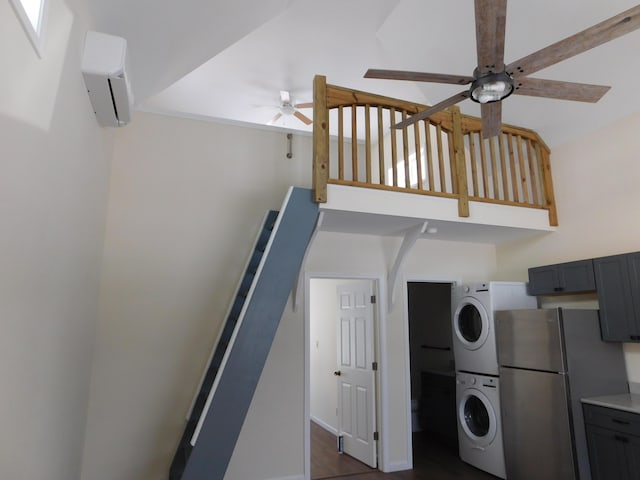 kitchen with ceiling fan, light countertops, stacked washer and clothes dryer, freestanding refrigerator, and a high ceiling