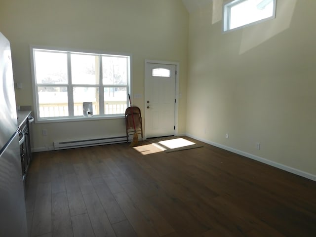 entryway with dark wood finished floors, plenty of natural light, baseboards, and a baseboard radiator