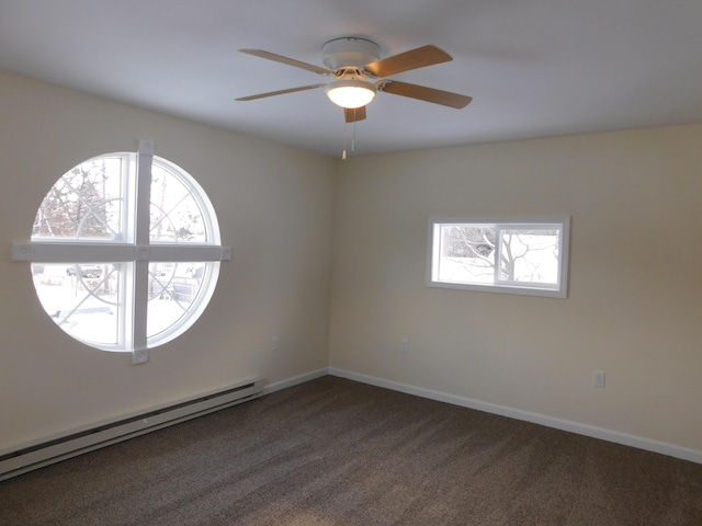 carpeted spare room featuring a ceiling fan, a baseboard heating unit, and baseboards