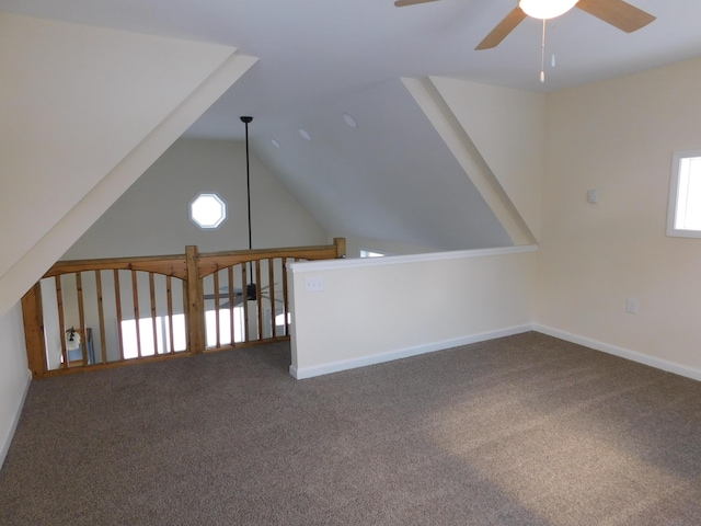 additional living space with a wealth of natural light, carpet floors, ceiling fan, and vaulted ceiling