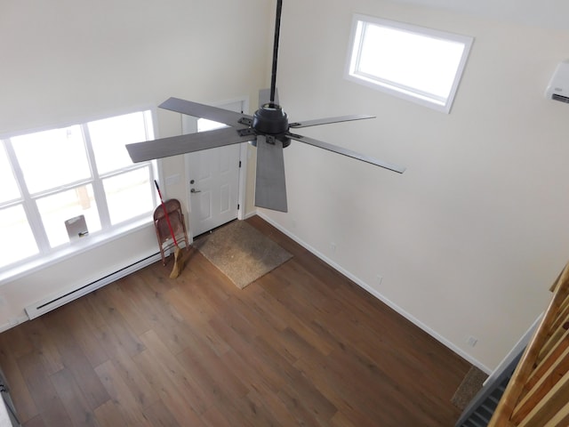 interior details featuring a ceiling fan, wood finished floors, baseboards, and baseboard heating