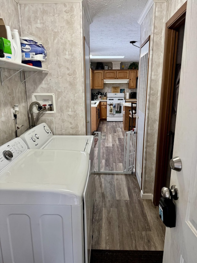 laundry room featuring laundry area, washer and dryer, a textured ceiling, and dark wood-type flooring